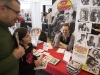 WINDSOR, Ont. (14/02/16) – Michigan-based comic book writer and artist Ted Woods (right) shows some of his artwork to a father and daughter while attending the 2016 Comic Book Syndicon at the St. Clair College Centre for the Arts in Windsor on Sunday, Feb. 14, 2016. Photo by Justin Prince